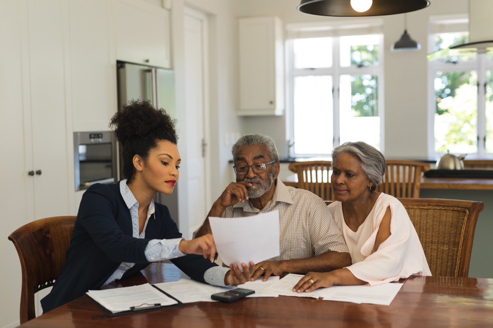 A retired couple reviewing their options at home